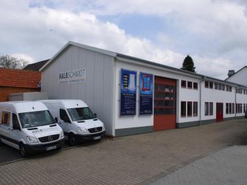 Maschinenhalle mit Transportern im Vordergrund